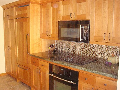 Kitchen w/ custom cabinets, integrated Sub-Zero, range top, oven